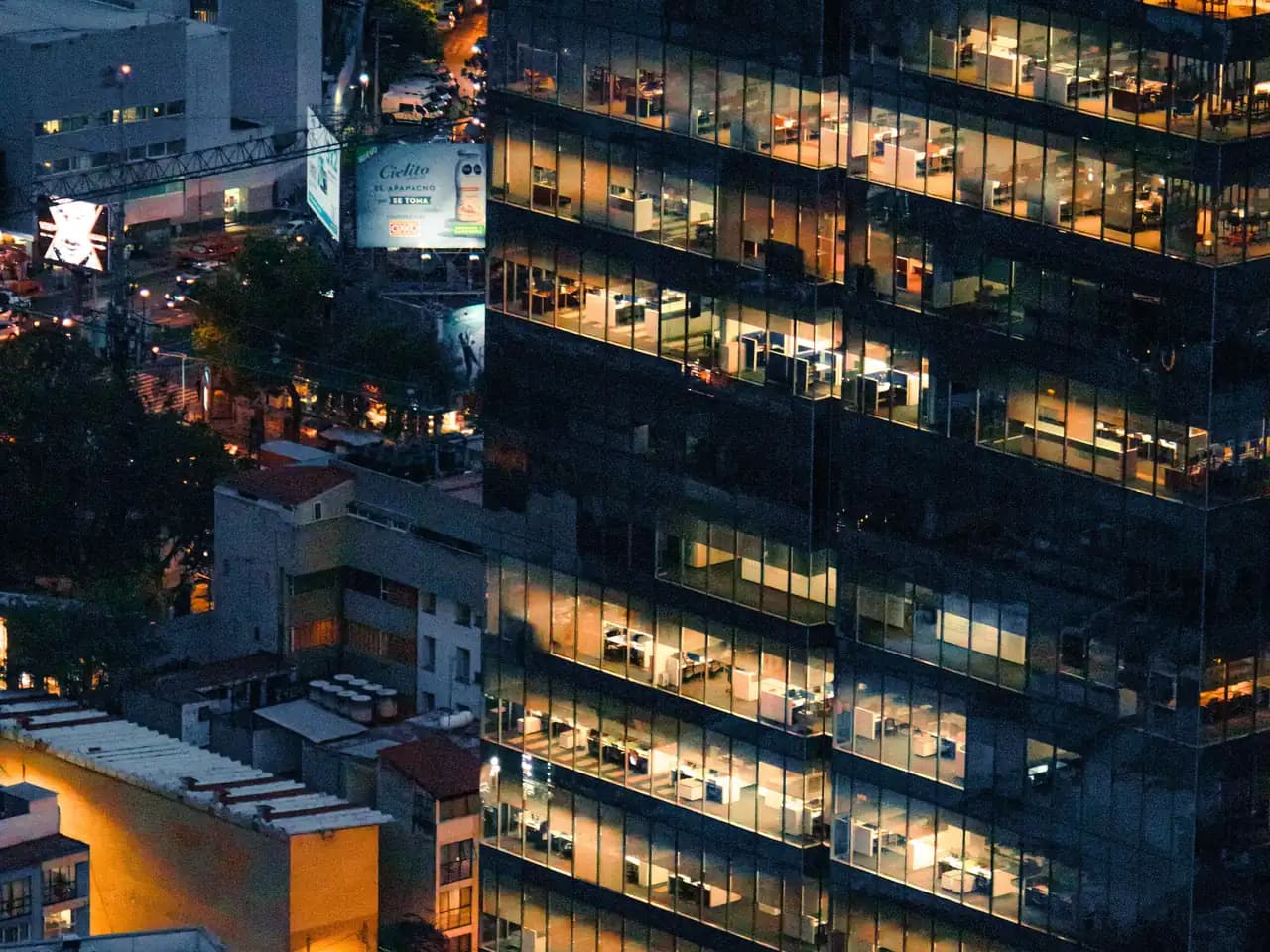 Facility exterior at night with occupied floors lit