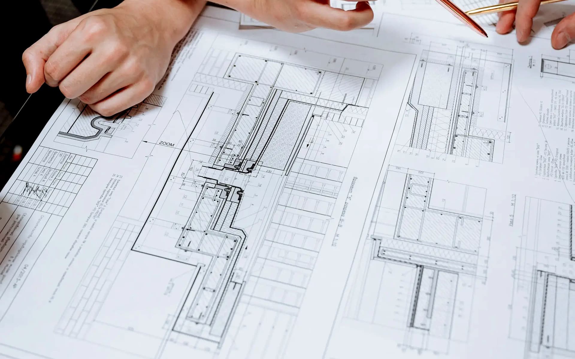 Facility drawings being marked up during a design review